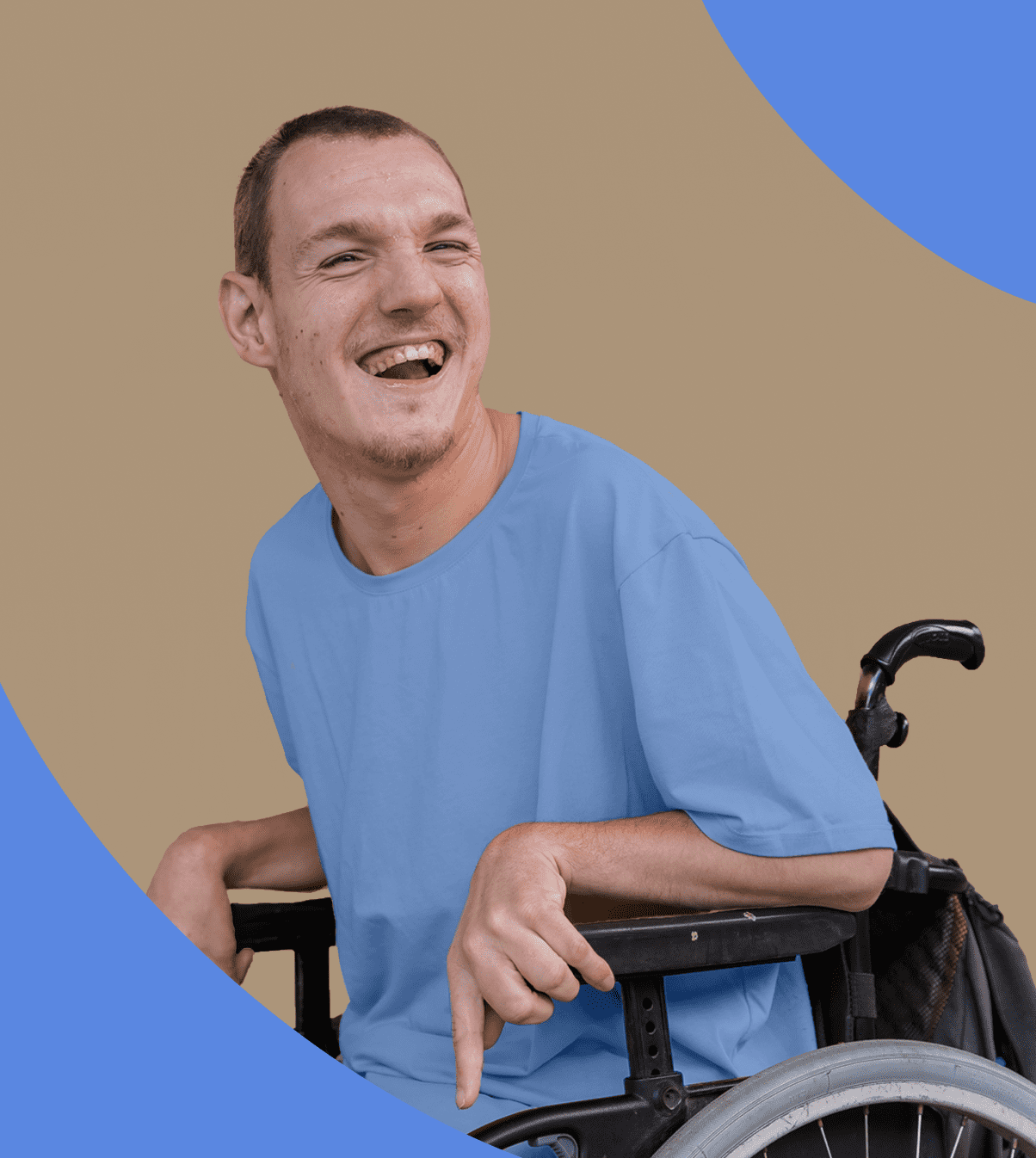 Man wearing a blue t-shirt sat in a wheelchair smiling